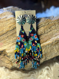 Multicolor seed bead fringe earrings with dark fan-shaped tops and bright southwestern beadwork