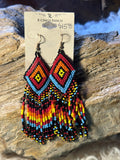 Southwestern geometric seed bead earrings in red, orange, yellow, blue and black with fringe