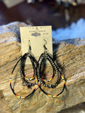 Long black seed bead hoop earrings with gunmetal-tone beads and red, yellow, and white accents