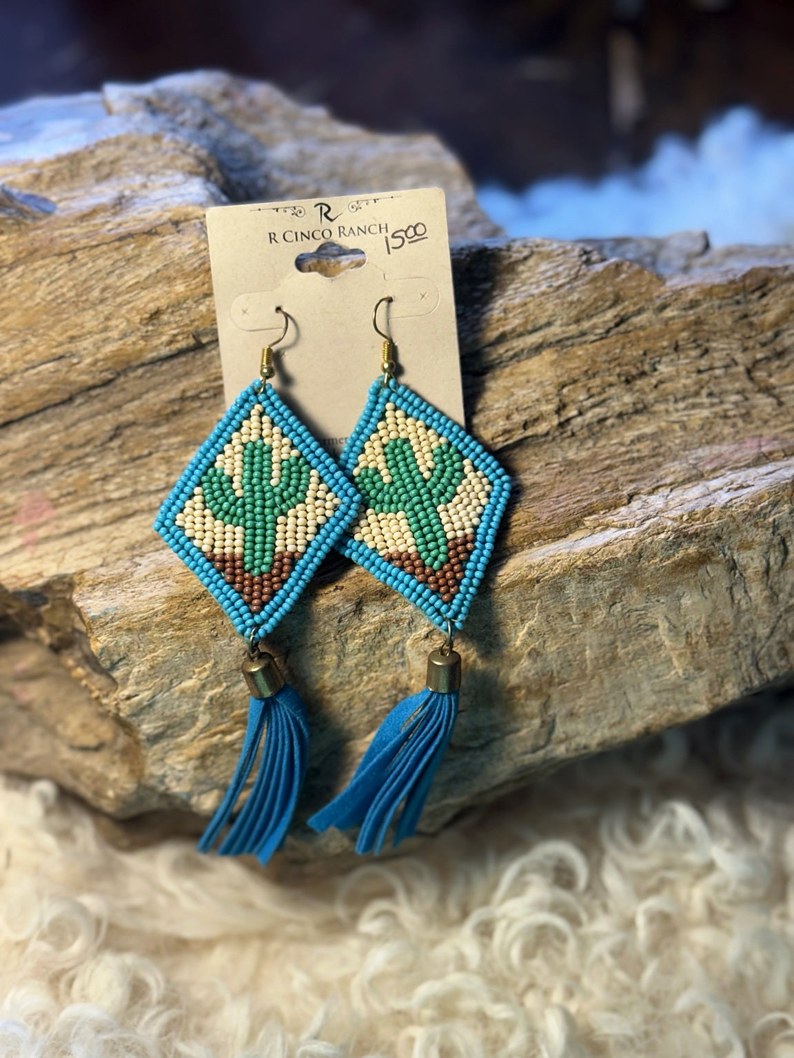 Turquoise-edged geometric seed bead drop earrings with cream, green, and brown beadwork