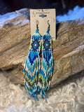 Extra-long turquoise and blue seed bead fringe earrings with green and cream diamond patterns and blue tassels