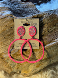 Hot pink oversized hoop earrings with colorful iridescent stones in oval seed bead tops