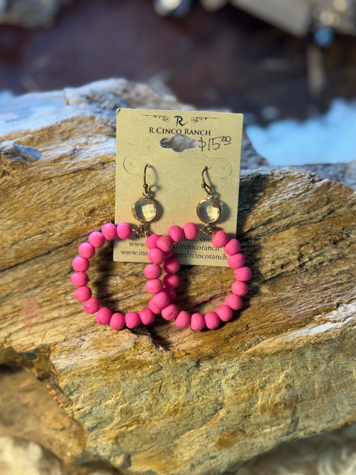Hot pink beaded hoop earrings with iridescent accents