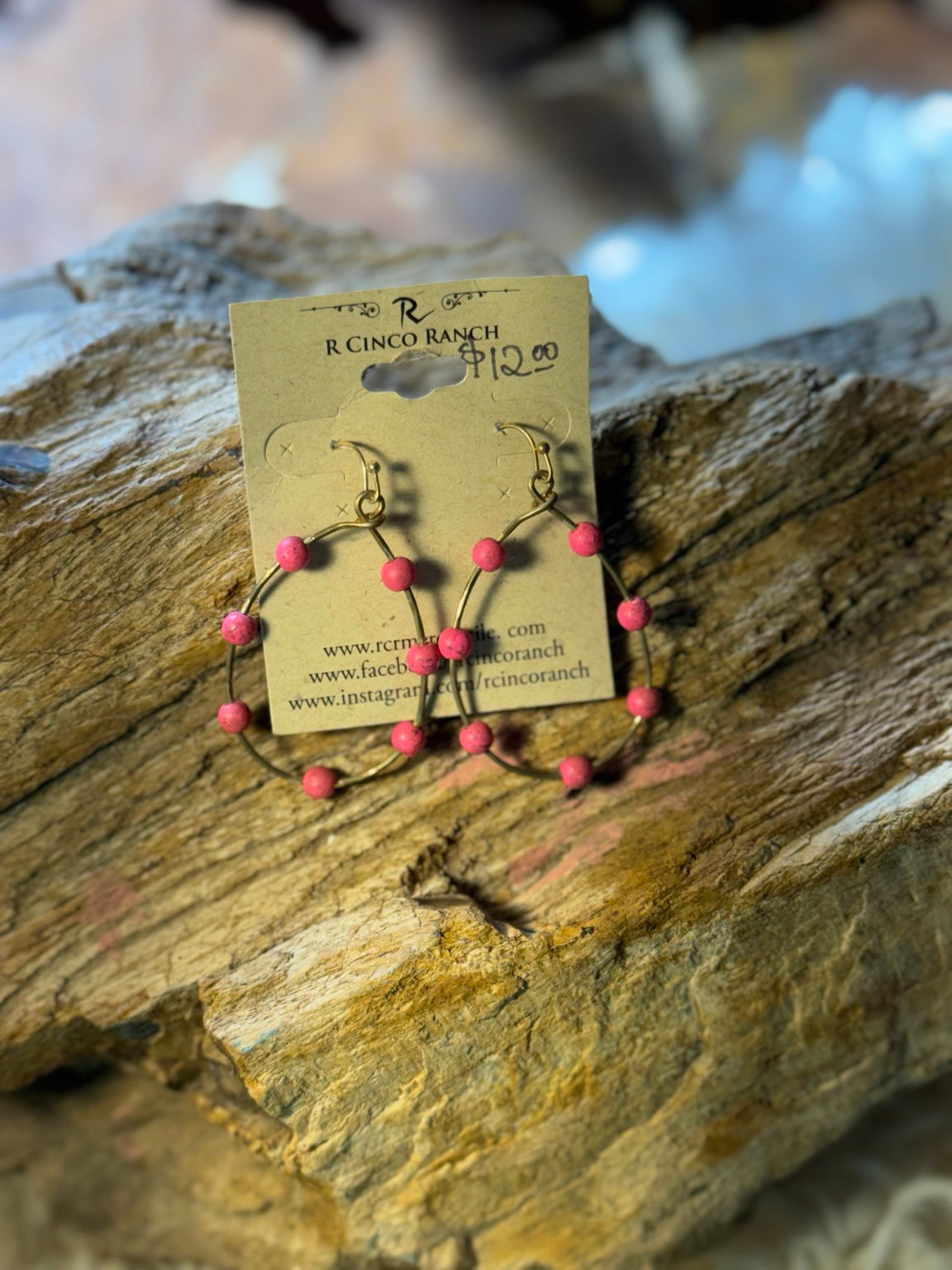 Bright pink woven hoop earrings with rose studs
