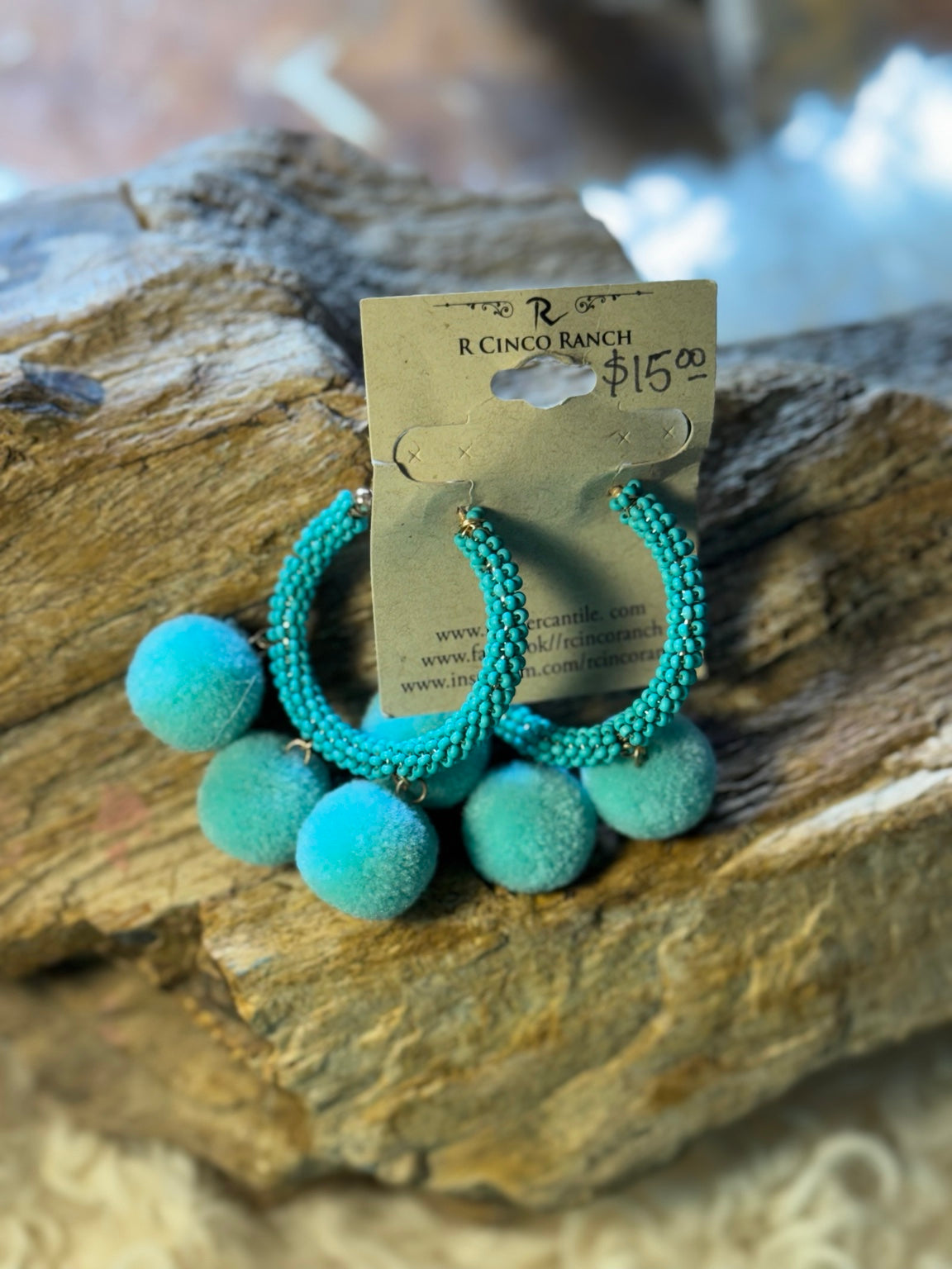 Turquoise beaded hoop earrings with pom-poms
