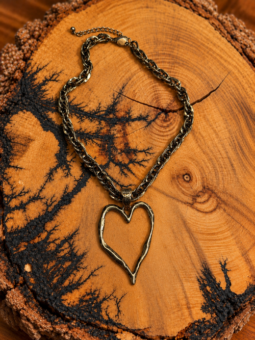 Antique Gold-Tone Open Heart Chain Necklace on rustic wood