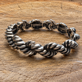 Antique silver-tone twisted link bracelet on natural wood