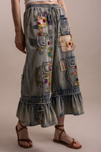 Close detail of embroidery and patchwork on Blue Velvet ruffle pants