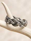 Braided antiqued silver-tone bracelet displayed on a white antler against an ivory background