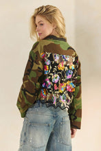 Close back view of multicolor floral sequin panel on camo jacket