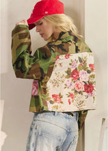 Close back view of floral fabric panel on camo jacket