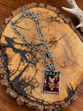 Cat portrait rectangular pendant necklace with silver-tone oval-link chain on rustic wood