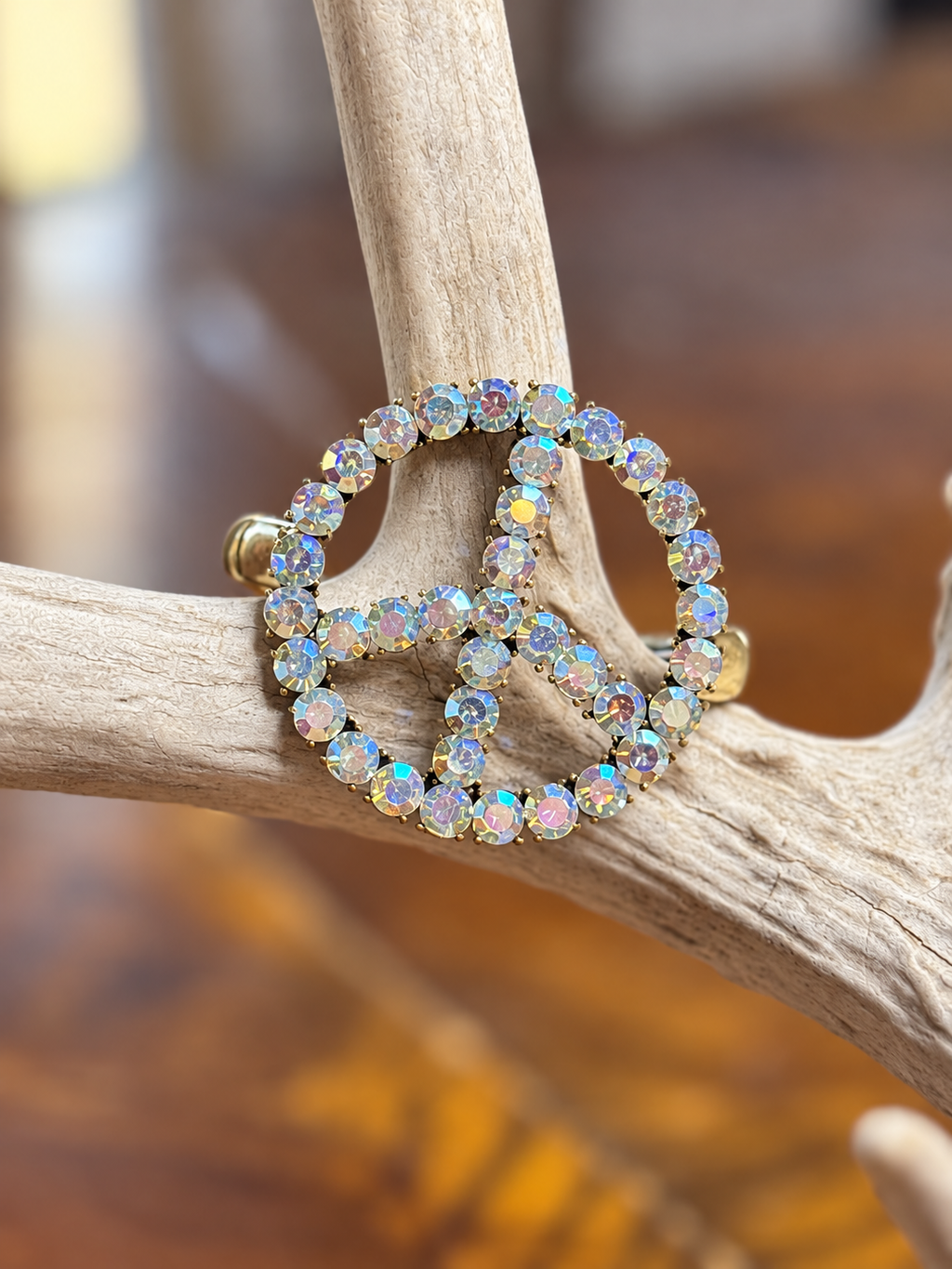 Clear rhinestone peace sign bracelet with gold-tone metal, front view