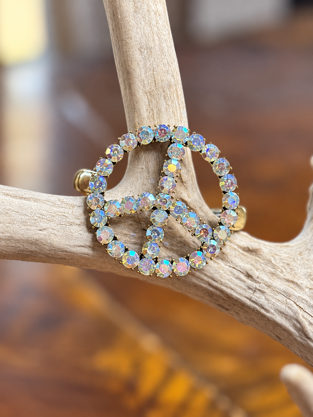 Clear rhinestone peace sign bracelet with gold-tone metal, front view