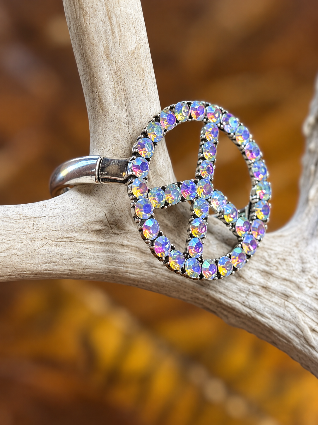 Clear rhinestone peace sign silver-tone bracelet, side view showing silver band