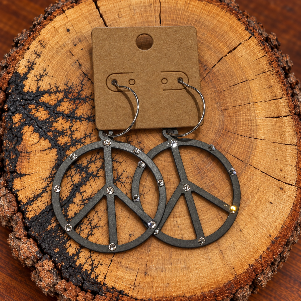 Crystal-Accent Peace Sign Hoop Earrings on a plain kraft card