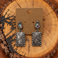 Western Scroll Rectangle Crystal Drop Earrings on a plain kraft card