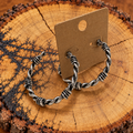 Silver-Tone Barbed Wire Hoop Earrings on a plain kraft card