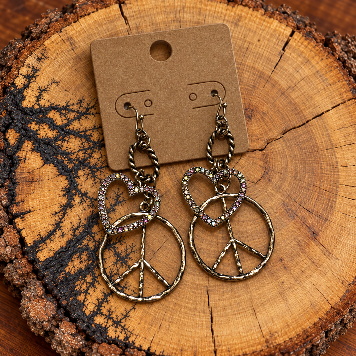Crystal Heart and Peace Sign Drop Earrings on a plain kraft card