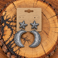 Silver-Tone Engraved Moon and Star Drop Earrings on a plain kraft card