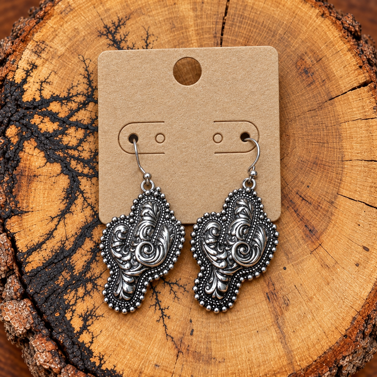 Silver-Tone Floral Scroll Cactus Drop Earrings on a plain kraft card