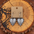 Silver-Tone Virgin Mary Heart Hoop Earrings on a plain kraft card