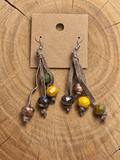 Earth-tone faceted bead tassel earrings on blank brown kraft card