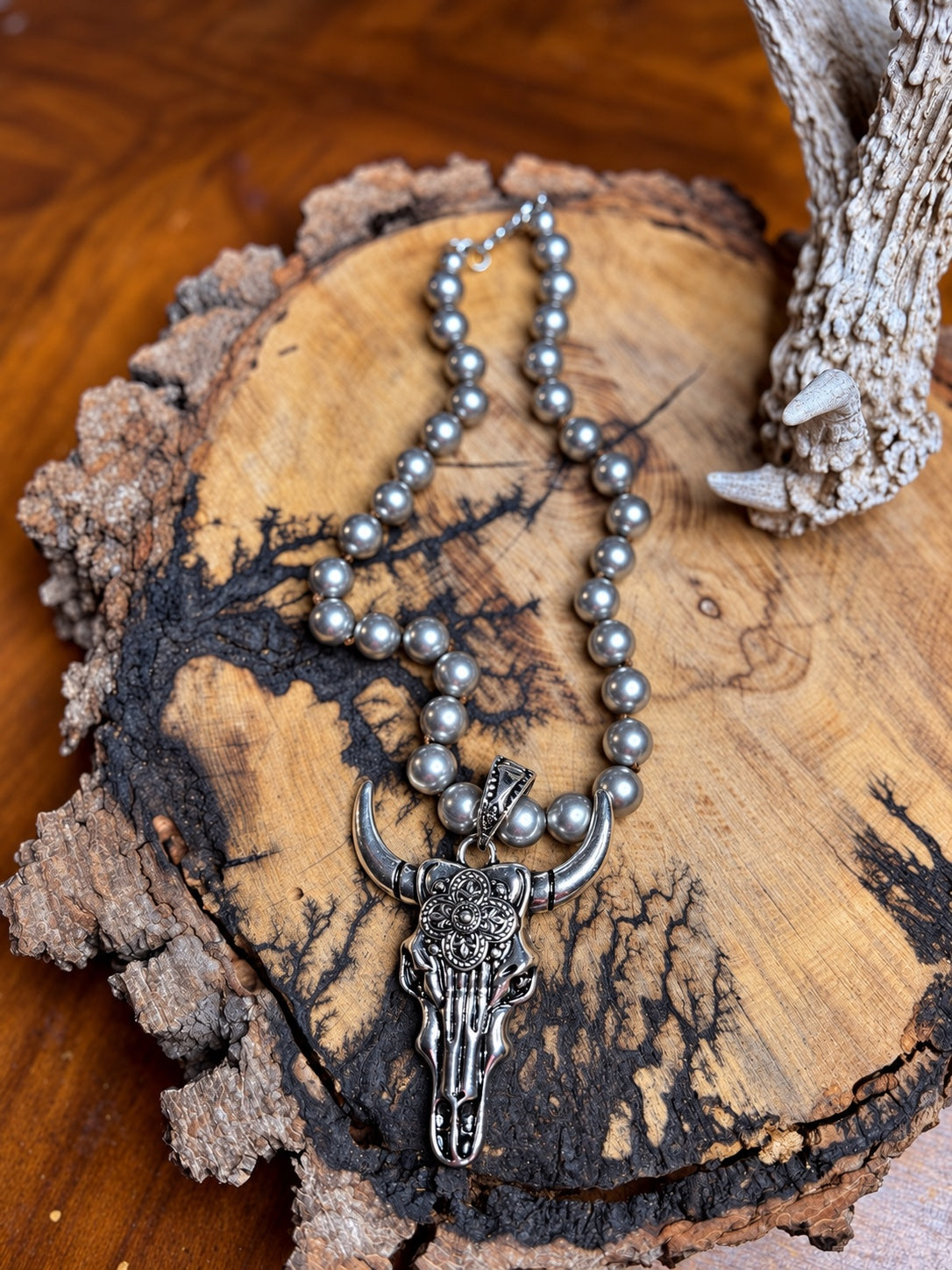 Floral longhorn skull pendant necklace with hand-knotted silver metal beads
