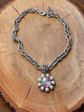 Iridescent Crystal & Pearl Flower Necklace – Silver-Tone Chain on natural wood