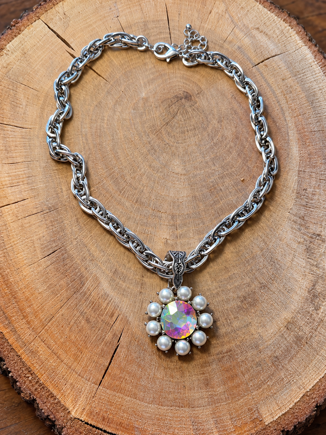 Iridescent Crystal & Pearl Flower Necklace – Silver-Tone Chain on natural wood