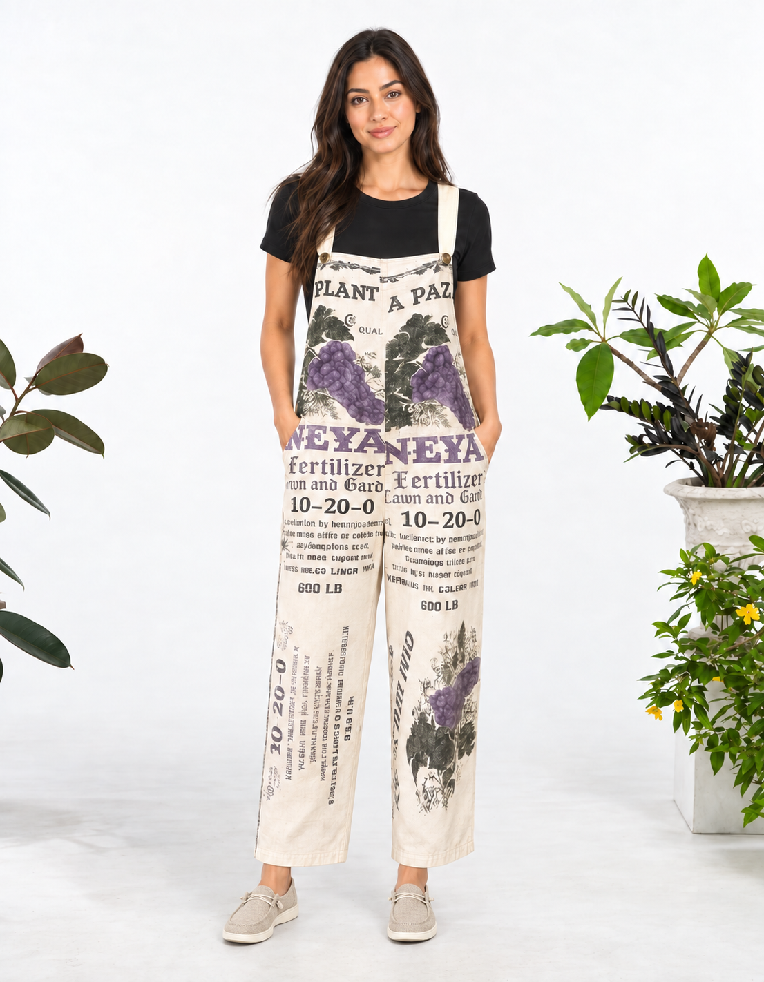 Model wearing the Grape vintage feed sack wide-leg jumpsuit with a black tee and neutral slip-on shoes