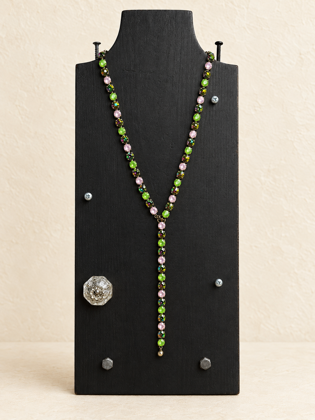 Green and pink magnetic Y necklace with medium Y drop on a black display