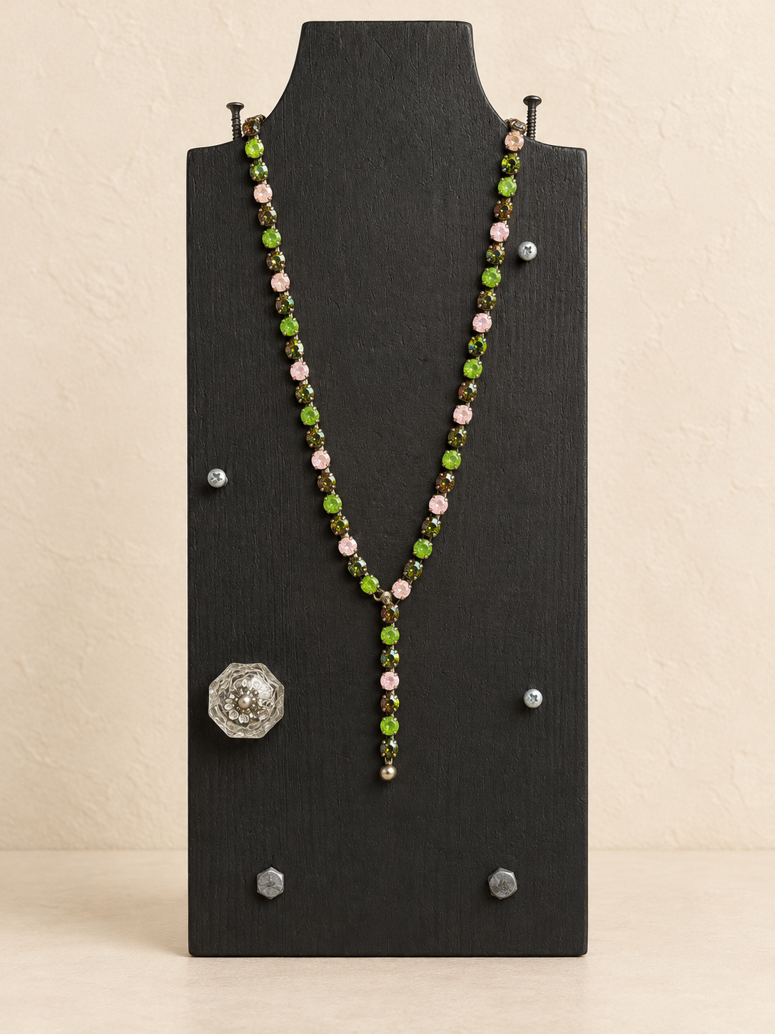 Green and pink magnetic Y necklace with short Y drop on a black display