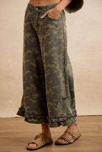 Side angle view of BIBI camouflage ruffle hem wide-leg pants