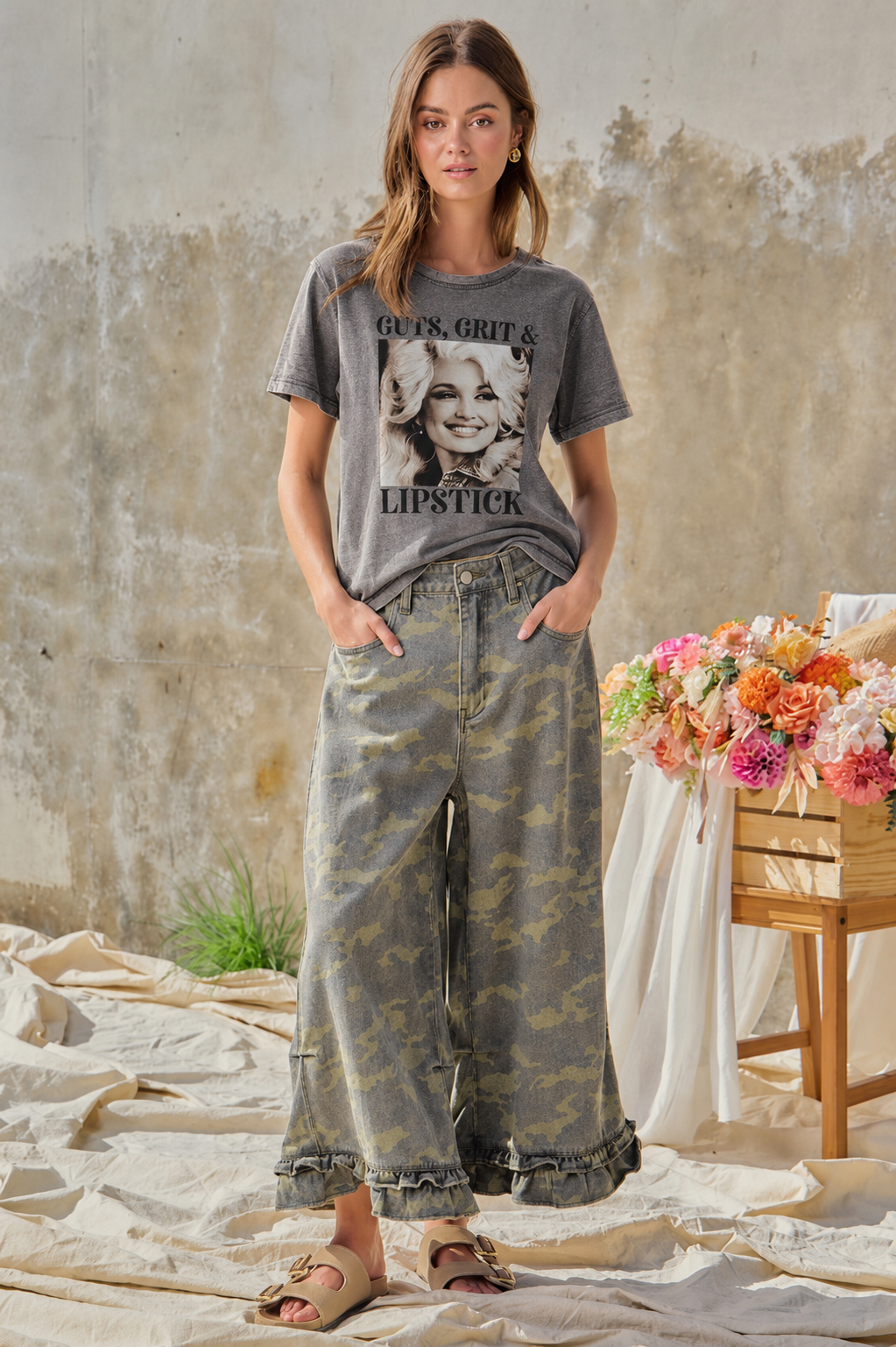 Model wearing Guts, Grit and Lipstick tee with BIBI camouflage ruffle hem wide-leg pants