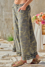 Side view showing pocket and wide leg of BIBI camouflage ruffle hem pants