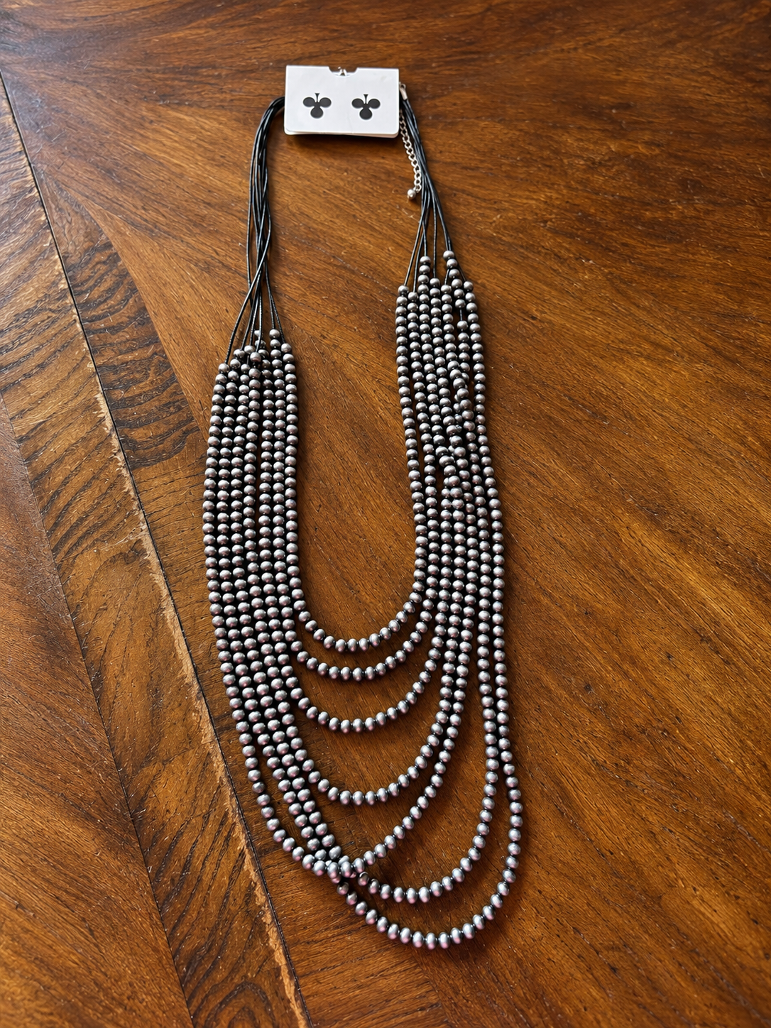 Long multi-strand necklace with gunsmoke silver beads on black nylon strands