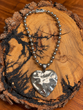 Hammered Silver-Tone Heart Necklace on rustic wood