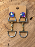 Iridescent crystal snaffle bit drop earrings on a plain kraft card