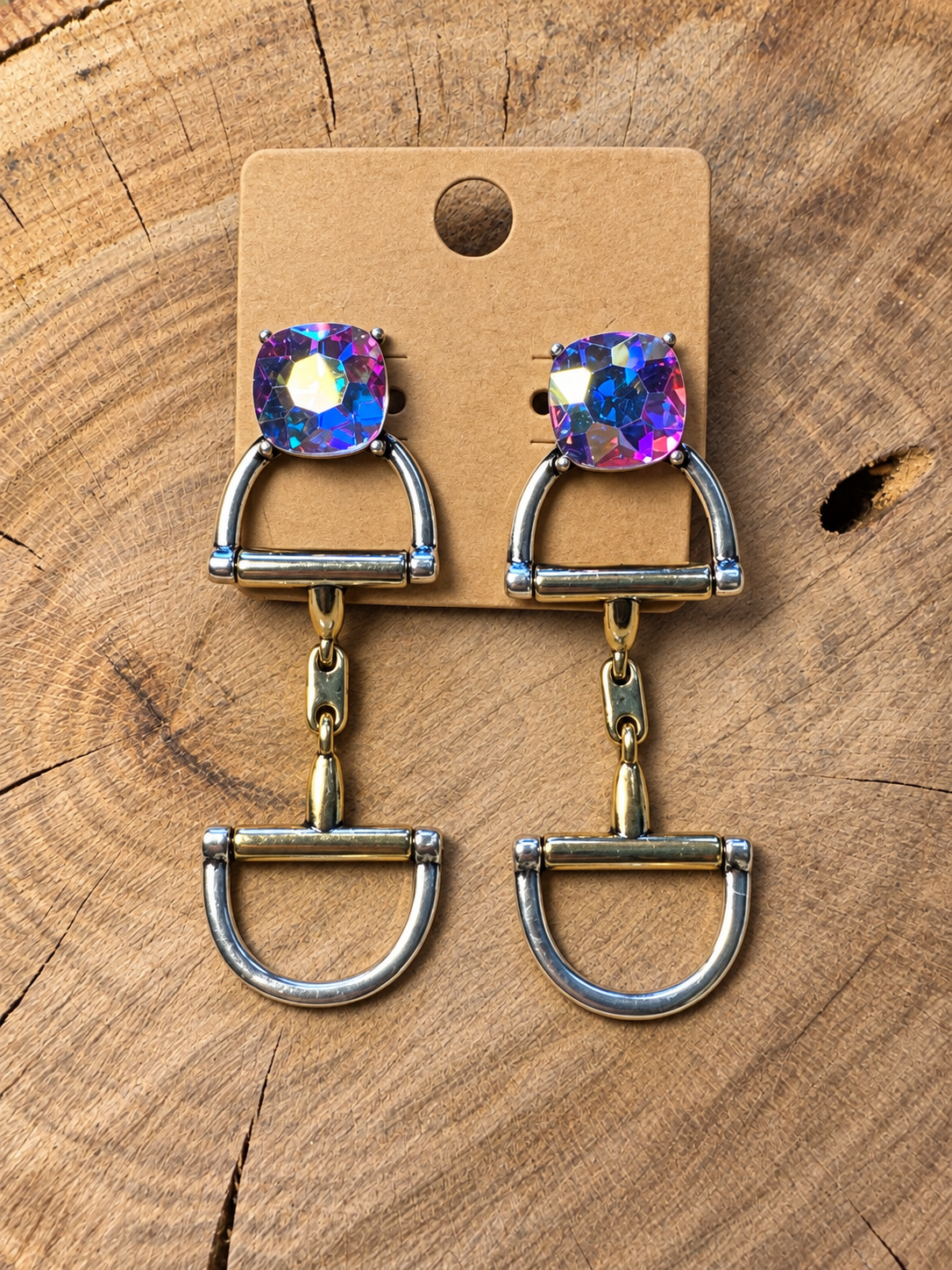 Iridescent crystal snaffle bit drop earrings on a plain kraft card