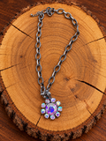 Iridescent Crystal Flower Necklace – Silver Link Chain on warm golden wood