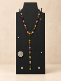 Multicolor crystal Y necklace on a black display stand