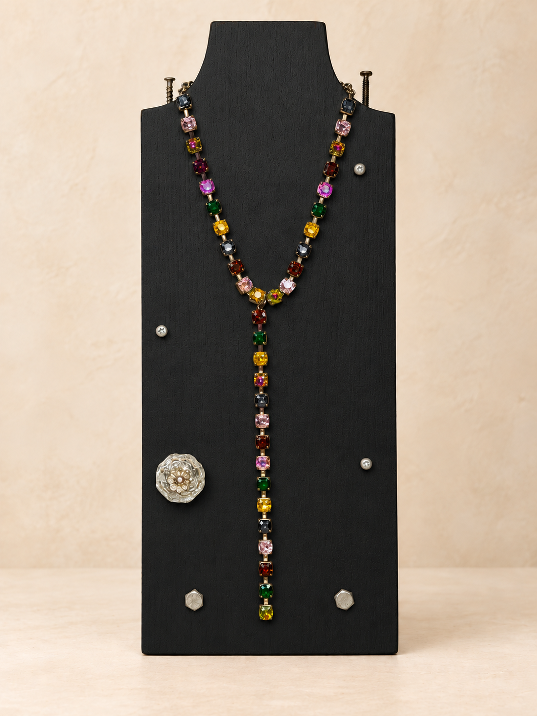 Multicolor crystal Y necklace on a black display stand