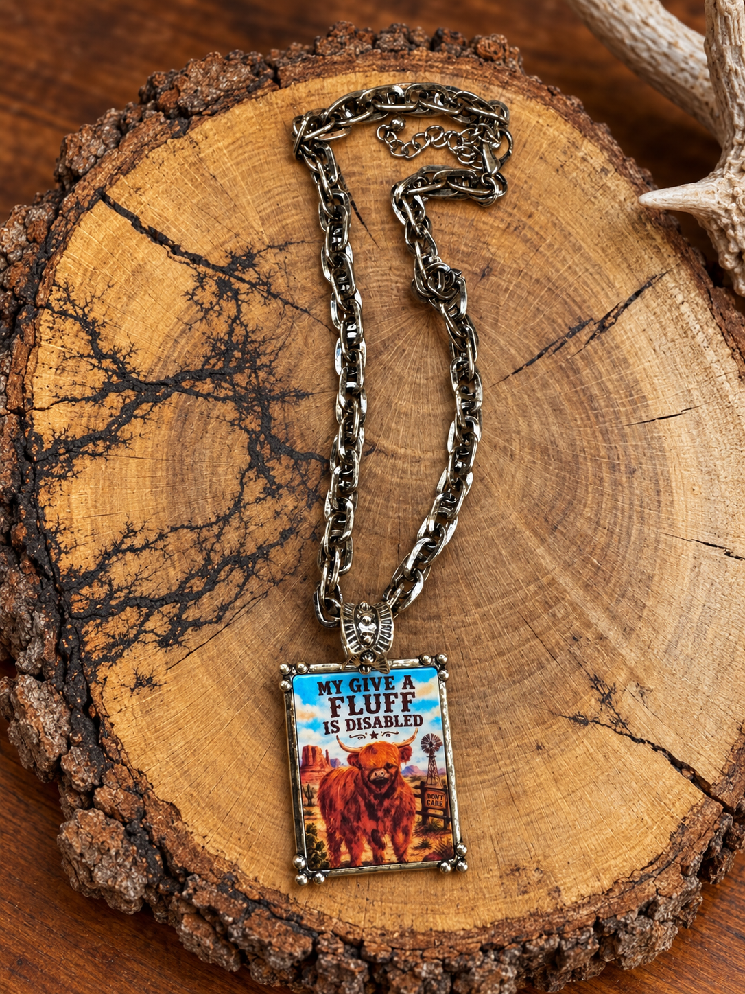 My Give a Fluff Is Disabled Highland cow pendant necklace with antiqued chain on rustic wood