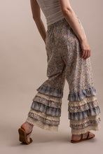 Back angled view of Peace and Patchwork tiered ruffle pants