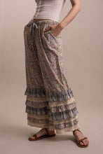Side view of Peace and Patchwork tiered ruffle pants