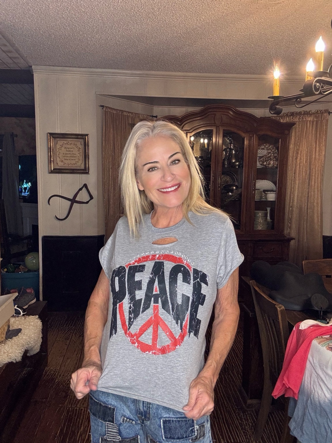 Heather gray tee with bold distressed PEACE lettering, a red peace sign, neckline cutout, and sparkling accents.