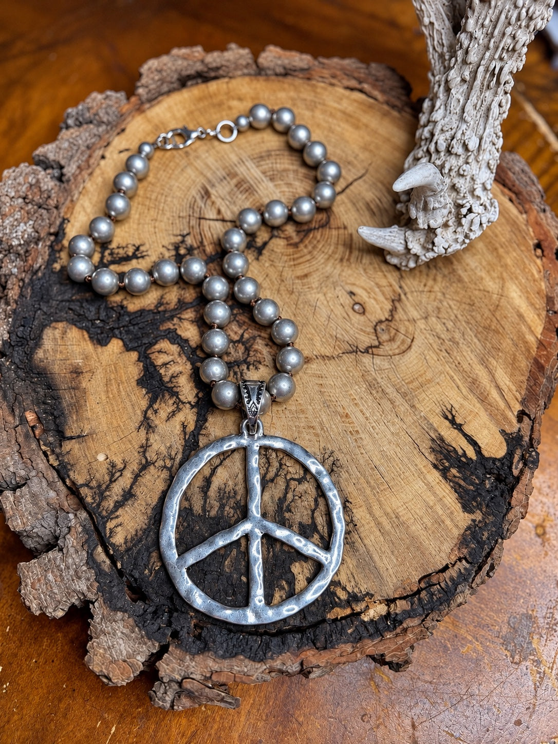 Hammered silver-tone peace sign pendant necklace with hand-knotted silver metal beads