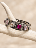 Antiqued silver-tone bracelet with a fuchsia heart, blush pink and clear crystals on an antler display
