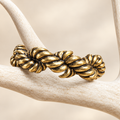Chunky antiqued gold-tone rope bracelet on white antler display